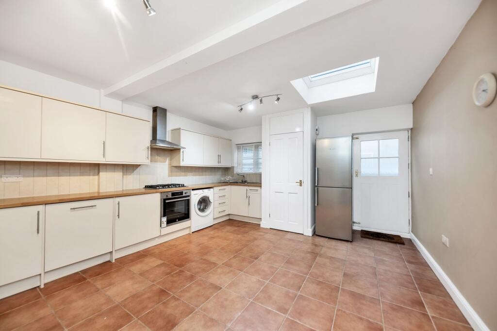 Lot: 79 - GROUND FLOOR FLAT SITUATED ON HIGH STREET - Kitchen with built in cabinets and back door